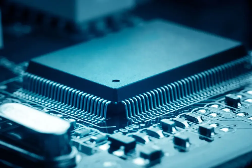 Close-up of an integrated circuit on a blue circuit board